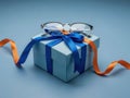 Gift box with ribbon and glasses isolated on white background Royalty Free Stock Photo