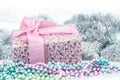 Gift box with ribbon near xmas decoration