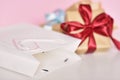 Gift box with ribbon and paper shopping bag on a pink background Royalty Free Stock Photo