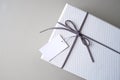 Gift box and ribbon with tag for valentine present. Royalty Free Stock Photo