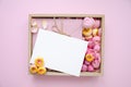 Gift box and rose buds and petals. Fresh flowers, craft envelope, blank card. Roses in a box pink roses, yellow roses. Fashion. Royalty Free Stock Photo