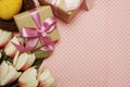 Gift box with roses bouquet with space copy on pink polka dot background Royalty Free Stock Photo