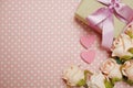 Gift box with roses bouquet with space copy on pink polka dot background Royalty Free Stock Photo