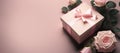 gift box with roses on pink background. mothers day, valentines day, aniversary. copy space. generative AI