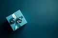 Gift box with satin ribbon and bow on blue background. Holiday gift with copy space. AI generated. Royalty Free Stock Photo
