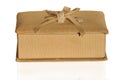 A Gift Box With A Shadow. A golden-colored jewelry gift box with a textured fabric lining with a jar highlighted on a white