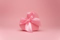 Gift box in the shape of a heart on a pink background isolated. Royalty Free Stock Photo