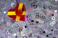 Gift box in the shape of a heart and tied with a red ribbon with a bow in the shape of a rose lies on the pillow fake fur studded Royalty Free Stock Photo