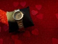 Gift box with silver watch is on red heart paper background