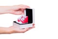 Gift Box with Small Red High-Top Canvas Shoes in Hands Royalty Free Stock Photo