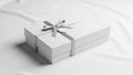 Gift box in a smooth matte white tied with a shiny silver ribbon Royalty Free Stock Photo