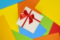 Gift box on the striped colored paper Royalty Free Stock Photo