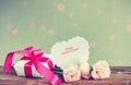 Gift box, three pink carnations, paper note