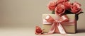 Gift box tied with pink satin ribbon with bouquet of delicate pink roses on pink blurred background. Royalty Free Stock Photo
