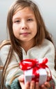 Gift box tied with a red ribbon in the hands Royalty Free Stock Photo