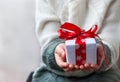 Gift box tied with a red ribbon in the hands Royalty Free Stock Photo