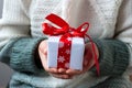 Gift box tied with a red ribbon in the hands Royalty Free Stock Photo