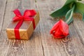 Gift box with tulip flower on the wooden background Royalty Free Stock Photo