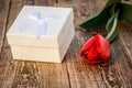 Gift box with tulip flower on the wooden background Royalty Free Stock Photo