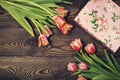 Gift box and tulip flowers on rustic table for March 8, International Womens day, Birthday or Mothers day, beautiful spring card Royalty Free Stock Photo