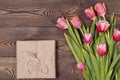 Gift box and tulip flowers on rustic table for March 8, International Womens day, Birthday or Mothers day, beautiful Royalty Free Stock Photo