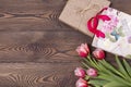 Gift box and tulips flowers on a rustic table on March 8, International Women`s Day, birthday or mother`s day, beautiful spring Royalty Free Stock Photo