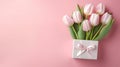 gift box and tulips on pink background