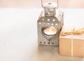 Gift box, vintage heart shaped candle holder with burning tea light on white background, Valentine`s day Royalty Free Stock Photo