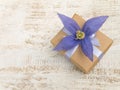 Gift box with violet four petals flower