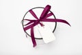 Gift box on a white background. mock-up. gift round white box with a burgundy bow on a light background in a row. surprise