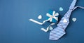 Gift box with white ribbon bow and tie on blue background, happy fathers day concept Royalty Free Stock Photo