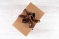 Gift box on a white wooden background. Parcel delivery service concept, delivery to quarantine from coronavirus