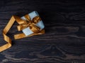 Gift Box on Wood Table, Wrapped Vintage Paper Present With Bow Lying on Brown Wooden Planks Royalty Free Stock Photo