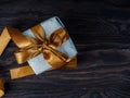 Gift Box on Wood Table, Wrapped Vintage Paper Present With Bow Lying on Brown Wooden Planks Royalty Free Stock Photo