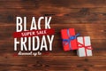 Gift box on a wooden background top view. Black friday sale Royalty Free Stock Photo