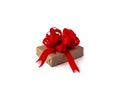 A gift box wrapped in brown craft paper, with a red ribbon and bow on a white, isolated background. concept celebration Royalty Free Stock Photo