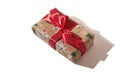Gift box wrapped in brown decorated recycled paper with red ribbon bow Royalty Free Stock Photo