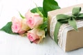 Gift box wrapped in brown paper, white lace and a green bow Royalty Free Stock Photo