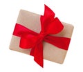 Gift box wrapped in brown recycled paper with red ribbon bow top