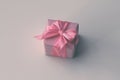 Gift box wrapped in craft brown paper and tie pink satin ribbon. White background. Royalty Free Stock Photo