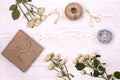 Gift box wrapped in kraft paper and flower, twine and scissors on a white wooden background from above. Flat lay styling Royalty Free Stock Photo