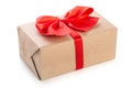 Gift box wrapped in kraft paper with red ribbon bow, isolated on white background Royalty Free Stock Photo