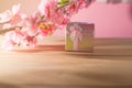 Gift box wrapped and plum blossom Christmas and Newyear presents with bows and ribbons, Christmas frame boxing day background. Royalty Free Stock Photo