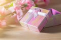 Gift box wrapped and plum blossom Christmas and Newyear presents with bows and ribbons, Christmas frame boxing day background. Royalty Free Stock Photo