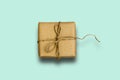 Gift box wrapped in recycled paper with ribbon bow Royalty Free Stock Photo