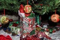 Gift boxes and bags under the Christmas tree with angel ornaments