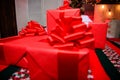 Gift boxes with big ribbon bow close up. Red wrapped gifts or presents. Prepare for christmas and new year. Wrapping Royalty Free Stock Photo