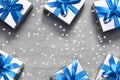 Gift boxes with blue ribbon on grey background with star Royalty Free Stock Photo