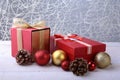 Gift boxes with bow and christmas balls on wood background. Decoration Royalty Free Stock Photo