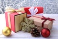 Gift boxes with bow and christmas balls on wood background. Decoration Royalty Free Stock Photo